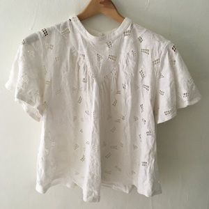 white lace-like cropped blouse